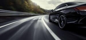 Rear View Red Business Car High Speed Turn Black Car Rushing Along Highspeed Background